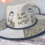 Custom white hat with message I am my own muse, with girls painted o the crown and minimalist abstract details on the brim